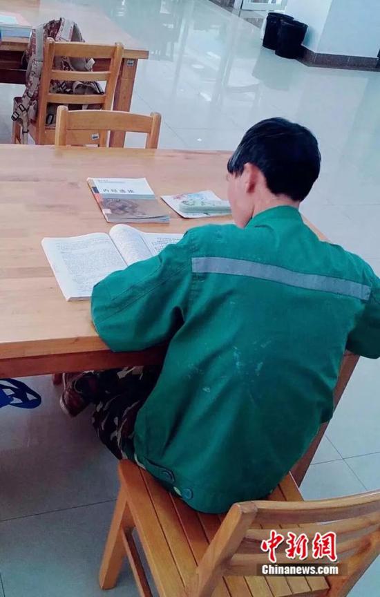 学校学生拍下的园丁大叔在图书馆学习的画面。云南中医学院提供
